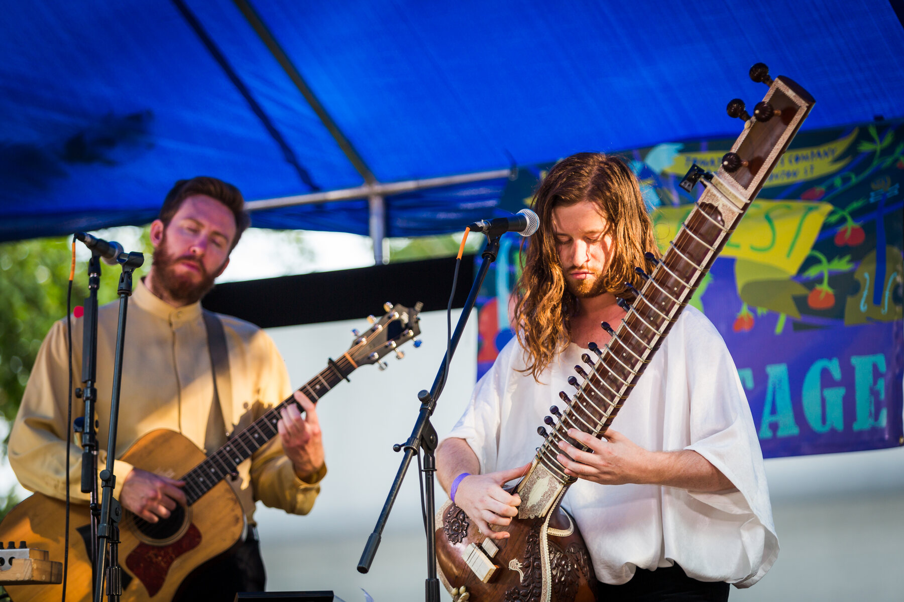 A guitarist and sitar player performing on the PaoliFest stage