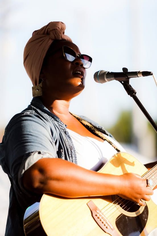 A singer and guitarist performing at PaoliFest