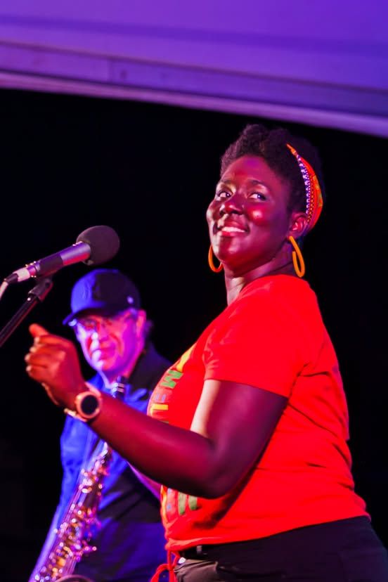 A vocalist smiling during her PaoliFest performance