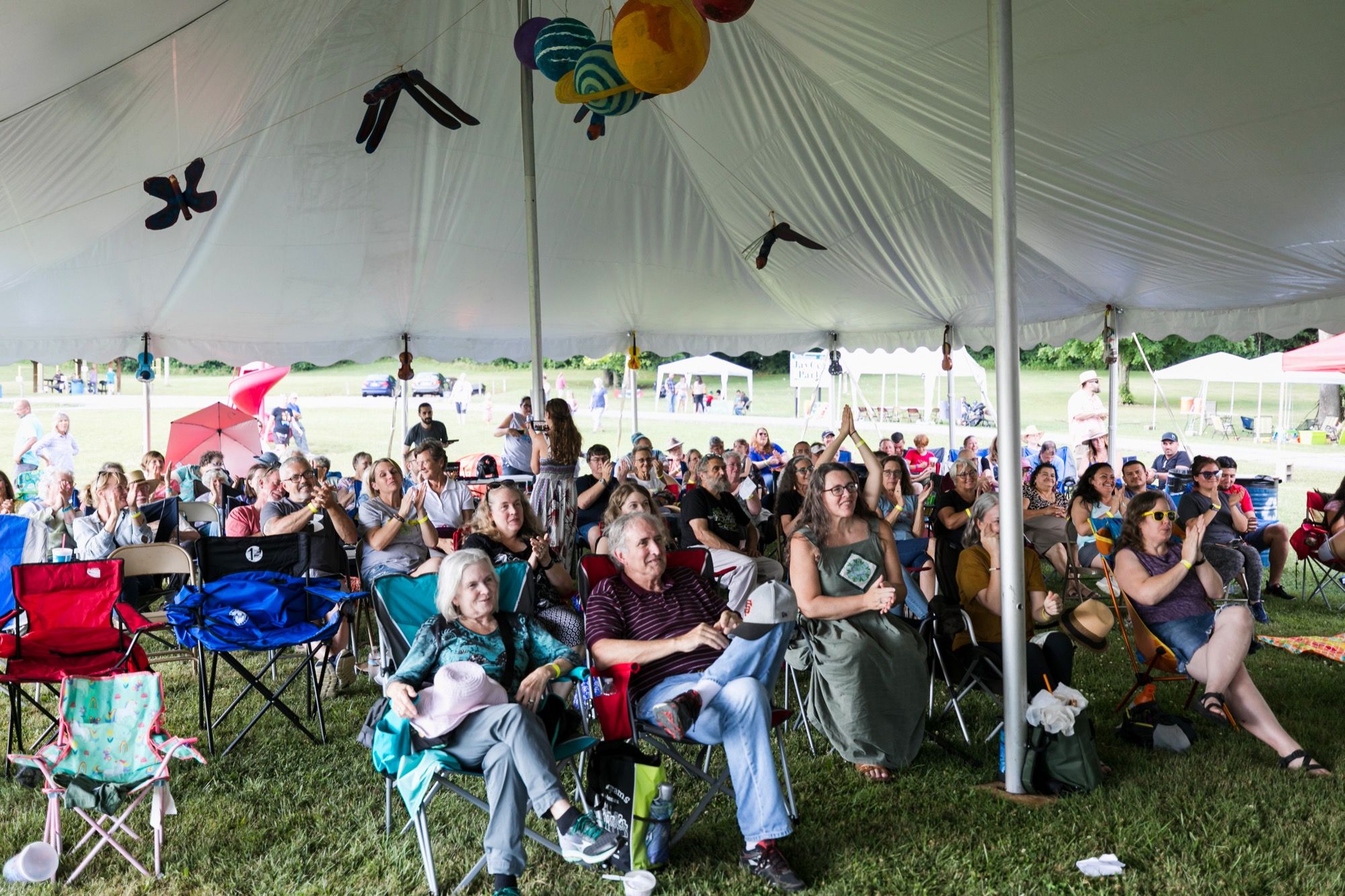 A multigenerational PaoliFest audience gathered under the festival tent